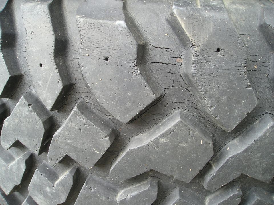 Close-up of cracked tire tread with visible holes