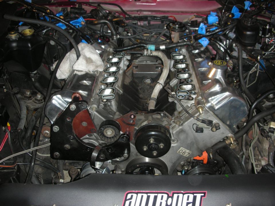 Engine during rebuild, showing intake manifold, supercharger, and pulleys. ANTR.net logo visible