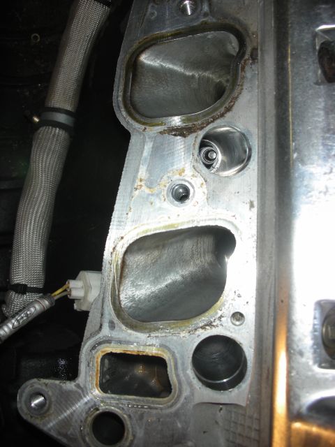 1992 Ford Crown Victoria - Close-up view of an engine cylinder head, showing the ports for intake and exhaust valves.