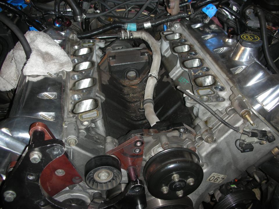 Ford V8 engine with intake manifolds removed, showing cylinder heads and accessory components