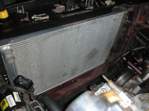 1992 Ford Crown Victoria - Close-up view of a radiator and engine components, with tools scattered nearby.
