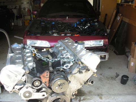 1992 Ford Crown Victoria - Engine and front end of a 1992 Ford Crown Victoria in a garage, undergoing repairs.
