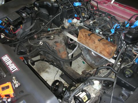 1992 Ford Crown Victoria - Engine bay during a rebuild, showing disassembled components and support structures.