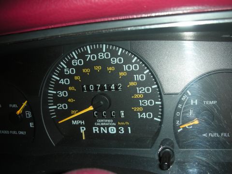1992 Ford Crown Victoria - Interior view of dashboard gauges, including the odometer showing 107,142 miles and the certified calibration indicator.