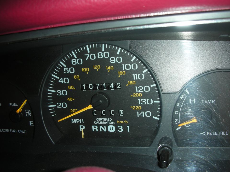 Dashboard gauges with odometer reading 107,142 miles