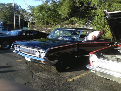 1960 Ford Falcon - A 1964 Mercury Comet is parked outdoors with its door open, while someone looks inside.