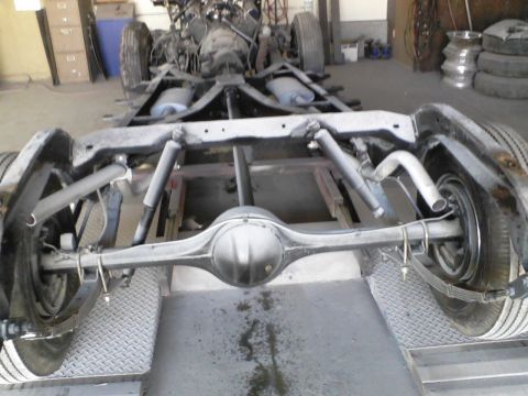 1960 Ford Falcon - Undercarriage view of a vehicle's rear axle and suspension components.