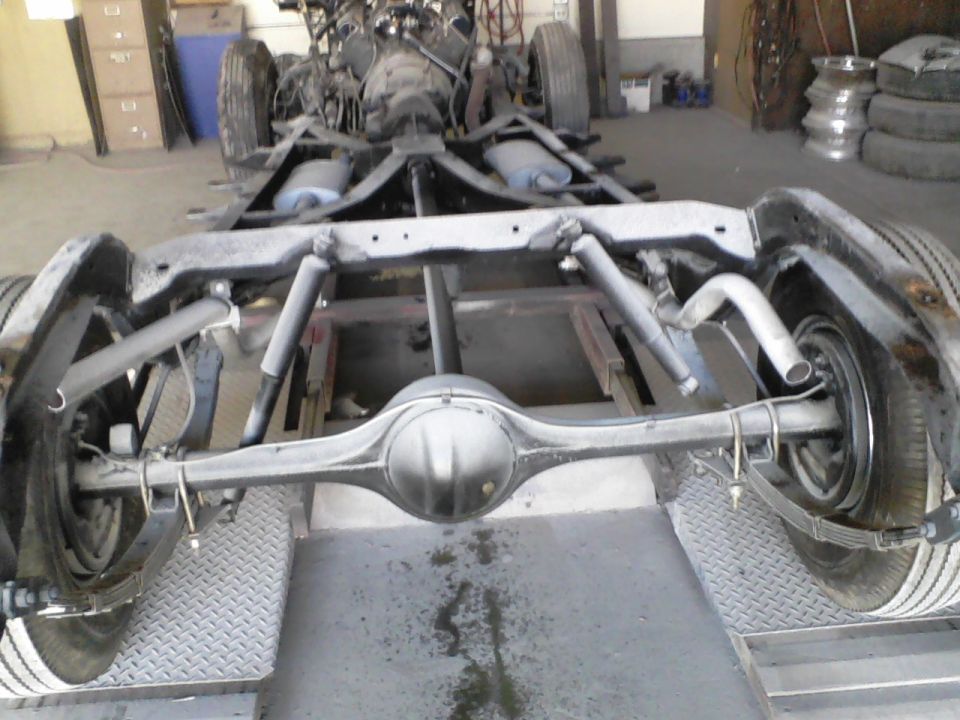Rear axle, leaf springs, shocks, and exhaust pipes of a vehicle chassis