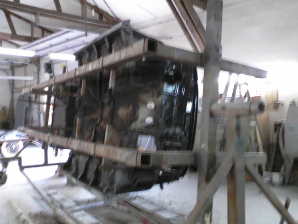 Car body on rotisserie, underside visible