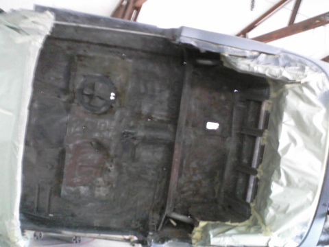 1960 Ford Falcon - The undercarriage of a vehicle is shown, appearing to be in a state of repair or preparation.