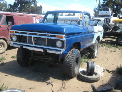 1978 Ford Bronco - This blue pickup truck, possibly a 1977 model, is parked outdoors with a spare tire nearby. The Supermotors logo is visible in the lower ri…