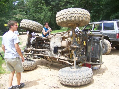 1992 Jeep YJ - An off-road buggy has overturned, with a Jeep Cherokee visible nearby.