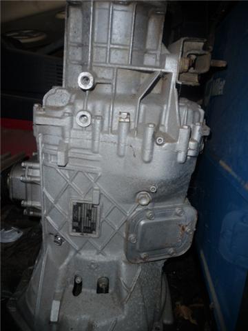 1990 Ford Bronco - Transmission housing with a metal data plate visible.