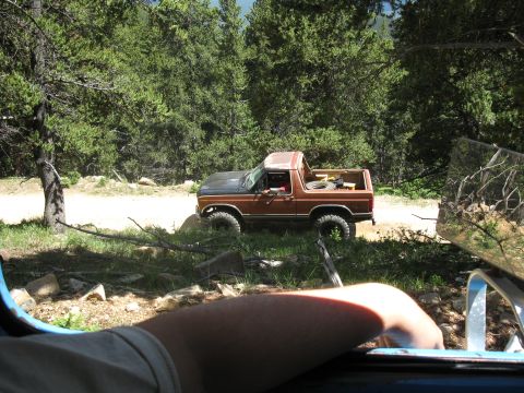1978 Ford F-150 - A 1978 Ford Bronco is seen off-road with a spare tire in its bed.