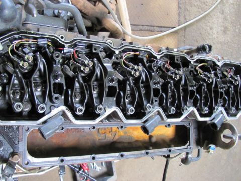 2005 Dodge 3500 - Close-up view of an engine's cylinder head, revealing internal components like rocker arms and fuel injectors.