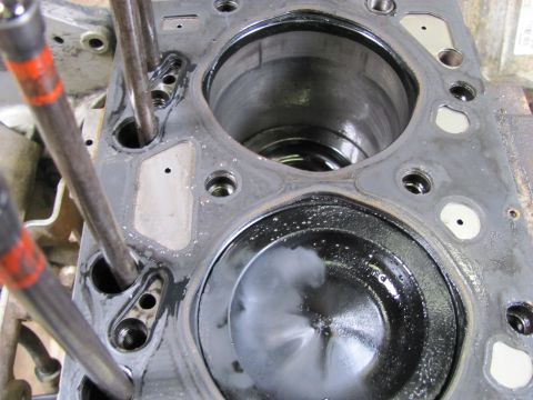 2005 Dodge 3500 - Engine cylinder head showing a piston and cylinder bore, with bolts in place.
