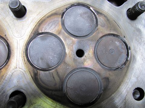 2005 Dodge 3500 - Close-up view of an engine cylinder head, showing four valves and signs of wear and carbon deposits.