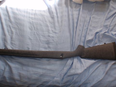1991 Ford Bronco - A rifle stock with a speckled gray finish is laid out on a blue cloth.