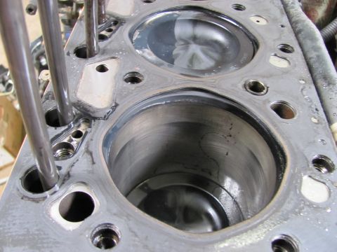 2005 Dodge 3500 - This is a close-up view of an engine's cylinder head, showing two of its cylinders and associated parts.