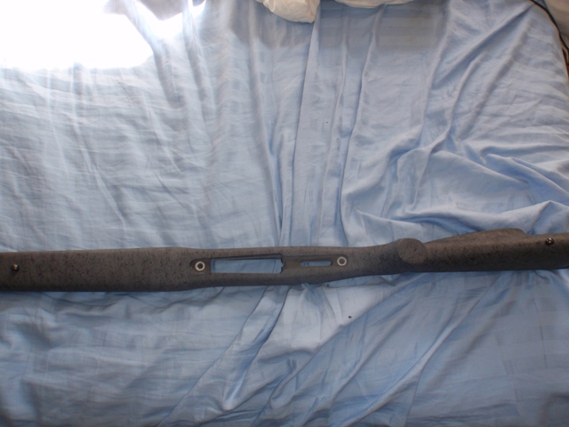 Gray speckled gun stock with a long cutout for a barrel and action