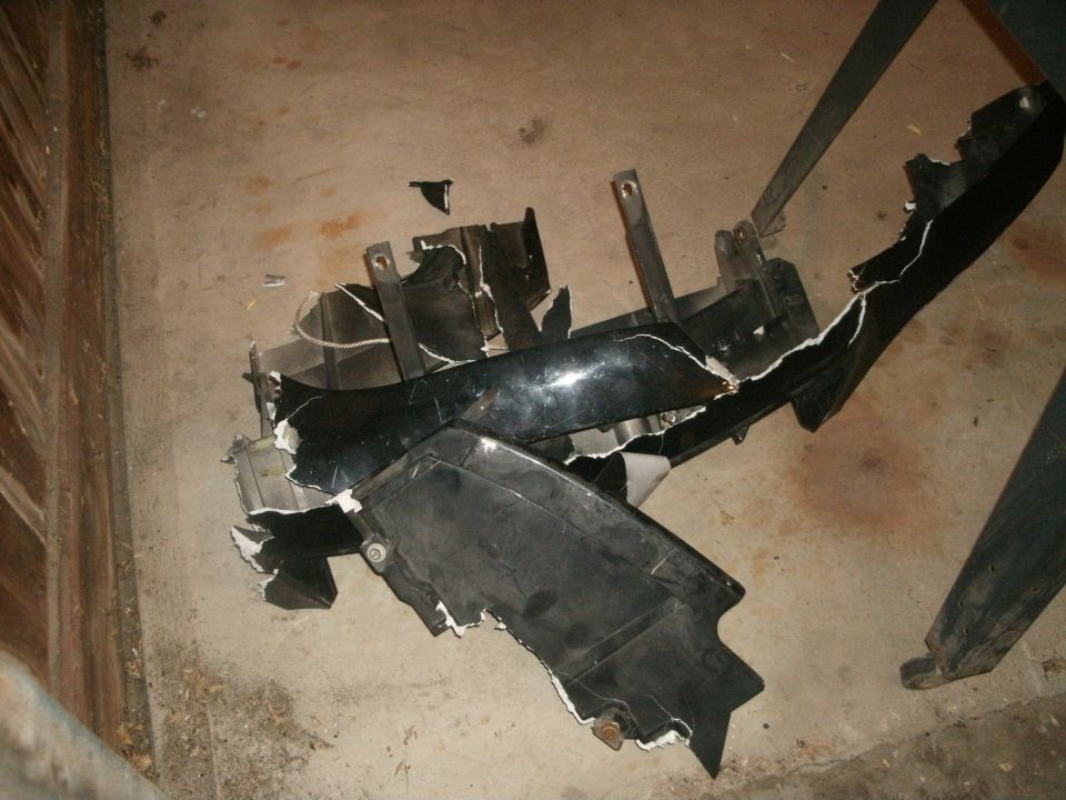 Broken black car bumper on concrete floor