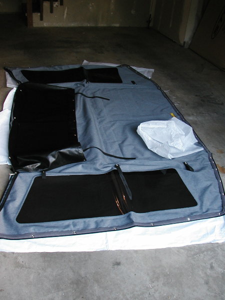 1995 Ford Bronco - A soft top for a vehicle is laid out flat, showing its construction and windows.