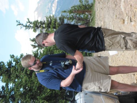 1978 Ford F-150 - Two men are in a scenic mountain location, with one man holding a camera around his neck.