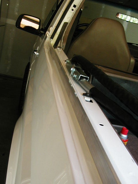 1995 Ford Bronco - The photo shows the interior of a vehicle with a focus on the hardware used for soft top installation.