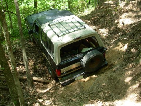 1983 Ford Bronco - The stump used to be where my LHR tire is, and now I'm more stuck than it was. I forgot to remove the drawbar, and now it's UNDER that root…