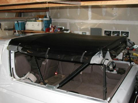 1995 Ford Bronco - Soft top installation in progress on a 1995 Ford Bronco, viewed from the side.
