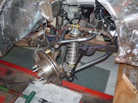 1969 MINI Cooper - This image shows a close-up view of a vehicle's front suspension and braking system, likely during a repair or modification.