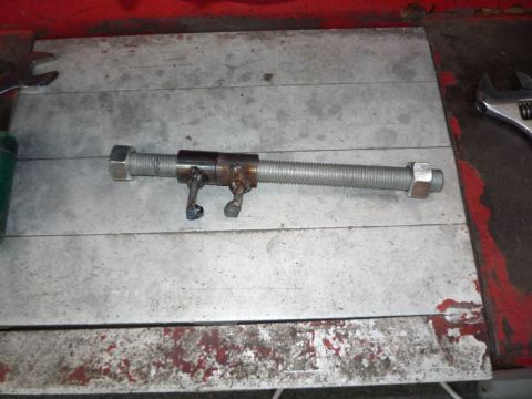 1969 MINI Cooper - A custom-made tool for spreading brake calipers is shown on a workbench, with wrenches nearby.