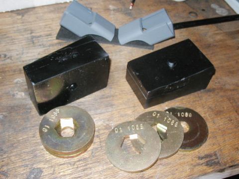 1995 Ford Bronco - Vehicle lift blocks and washers are shown on a wooden surface.