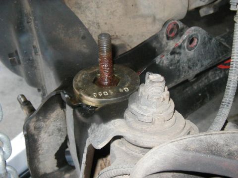 1995 Ford Bronco - Close-up of a suspension lift spacer installed on a vehicle's ball joint.