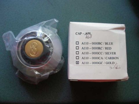 1997 Ford Taurus - A close-up shows a wheel center cap with a gold emblem, alongside its product packaging detailing various color choices.