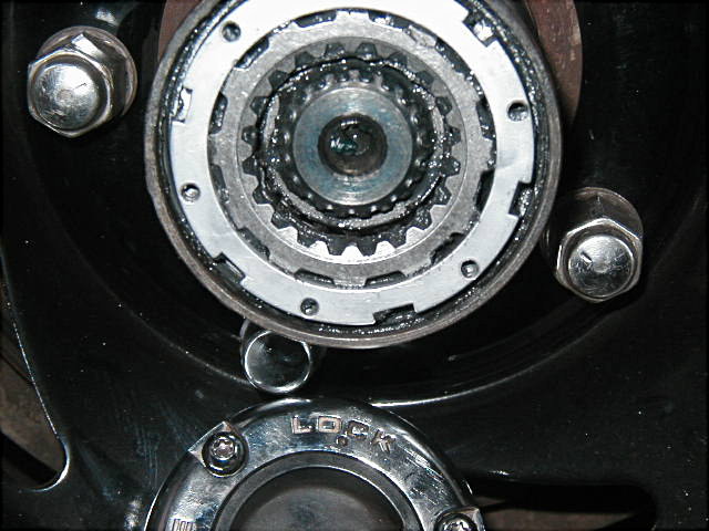 Close-up of an automatic locking front hub with exposed axle splines and gear teeth