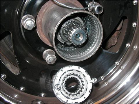 1995 Ford Bronco - Disassembled wheel hub assembly showing the splined axle and locking mechanism components.