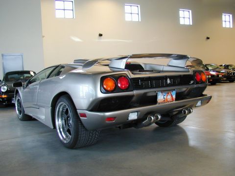 1998 Ford Crown Victoria - A silver Lamborghini Diablo is parked indoors, with other vehicles visible in the background.