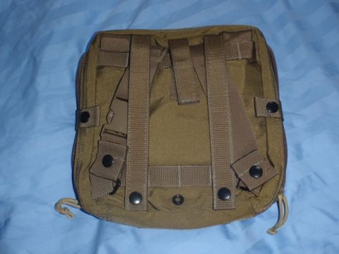 1991 Ford Bronco - This is a close-up view of the back of a tan tactical pouch, showing its attachment straps and buckle.