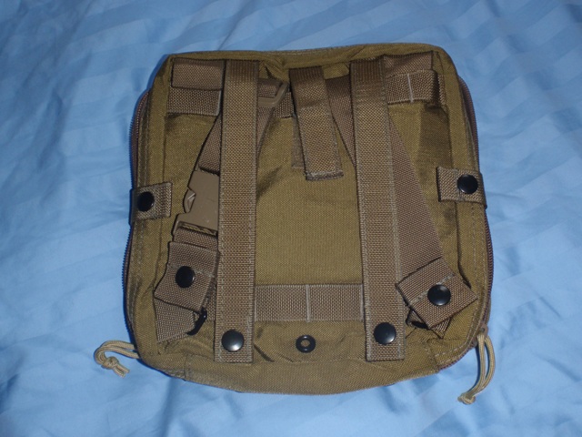 Tan tactical pouch with MOLLE straps and a buckle, lying on a blue surface