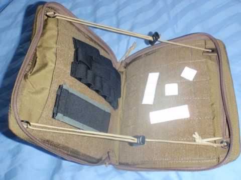 1991 Ford Bronco - A tan tactical pouch is open, revealing elastic straps and velcro patches inside.