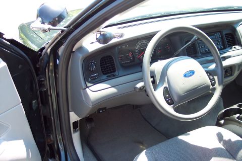 2001 Ford Crown Victoria - The interior of a 2001 Ford Crown Victoria police car, viewed from the driver's side.