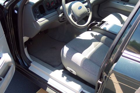 2001 Ford Crown Victoria - The interior of a 2001 Ford Crown Victoria is shown, cloth seats and the dashboard area.