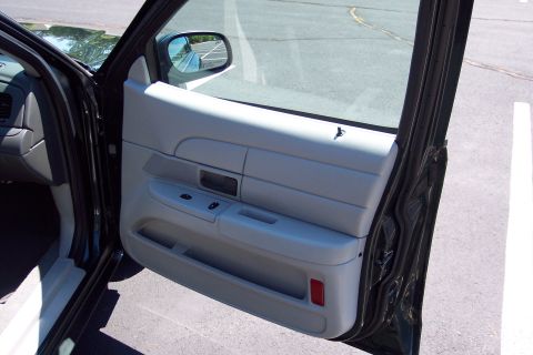 2001 Ford Crown Victoria - Interior view of the front passenger door panel of a car.