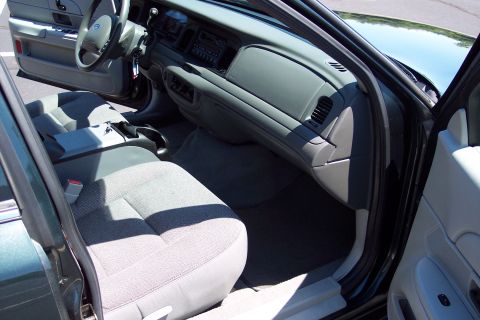 2001 Ford Crown Victoria - The interior of a Ford Crown Victoria shows fabric seats and the dashboard area.