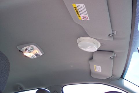 2001 Ford Crown Victoria - Interior view of a car's ceiling, showing the dome light and sun visors.