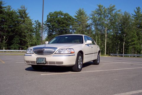2001 Ford Crown Victoria - This 2004 Lincoln Town Car is seen from a three-quarter front view in an outdoor parking lot.