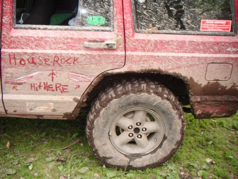 1998 Jeep Cherokee - Muddy red 1998 Jeep Cherokee side profile, showing graffiti and off-road tires.