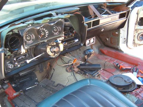 1973 Ford Ranchero - The interior of a 1973 Ford Ranchero is shown with the dashboard disassembled, revealing exposed wiring and components.