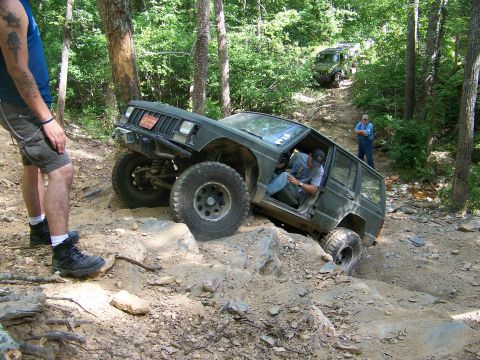 1992 Jeep YJ - A Jeep Cherokee XJ navigates a challenging off-road course with another vehicle following behind.